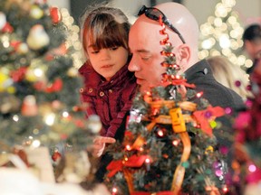 Don Boyd and daughter Roman Boyd, 6, check out miniature trees at the Festival of Trees on Saturday at the TEC Centre. The annual event is a major fundraiser for the QEII Hospital Foundation and featured live entertainment, tasty treats, crafts and all kinds of Christmas displays. (Adam Jackson/Daily Herald-Tribune)