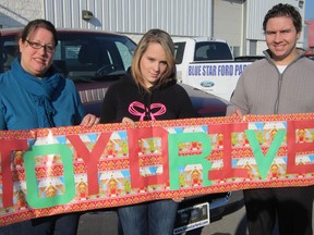 High school student Paige Moyce, 16, centre, has launched a Christmas toy drive in partnership with Blue Star Ford in Simcoe. At left is Sonya Van Dyk, a representative of Haldimand-Norfolk Women’s Services, while at right is Blue Star representative Kyle Kowtaluk. (MONTE SONNENBERG Simcoe Reformer)