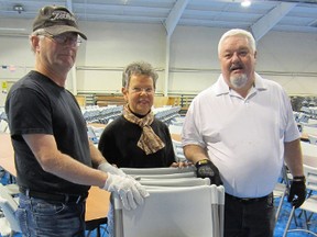 The Simcoe Lions Club took on the big job Monday of setting up The Aud for Tuesday’s Holiday Soup Luncheon.  Among those setting up tables and chairs were, from left, Dave Stelpstra, Liz Harvey and Brook Shafto, all of Simcoe. The event, a fundraiser for food banks in Norfolk County, begins at 11:30 a.m. and runs till 1:30 p.m. (