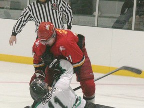 The Lucknow Lancers and Ripley Wolves faced off in the second chapter of the Battle of Huron-Kinloss on Friday, November 16, 2012. Ripley continued to dominate the Lancers, winning the game by a final of 8-1. Here, Tucker Dorscht of the Lancers takes out his frustration over the loss on an unsuspecting Darren Gavey near the end of the third. (JOHN F. ADAMS/KINCARDINE NEWS FREELANCE)