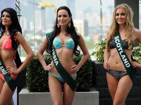 Contestants (L-R) Aisha Valy of Reunion Island, Natalia Pereverzeva of Russia, and Sara Pender of Scotland pose for photographers during a press presentation of the Miss Earth beauty pageant at a hotel in Manila on November 6, 2012.   AFP PHOTO/TED ALJIBE
