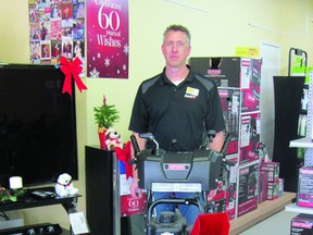 Store owner Aron Wiebe of Sears in Portage la Prairie stands with a Craftsman snowblower that will be reduced by $500 to $899.99 during Black Friday sales taking place at the store from Nov. 22 to Nov. 26. (ROBIN DUDGEON/THE DAILY GRAPHIC/QMI AGENCY)