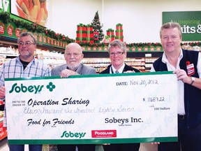 Steve Giuliano, program director and chaplain with Operation Sharing, and Frank Smith, president of Operation Sharing, left, accept a donation of $11,687 for Operation Sharing's Food for Friends program from Sheila Wammes, manager of the Sobeys store on Devonshire Avenue, and Chris Chapman, owner/operator of Woodstock Foodland on Dundas Street, on Tuesday, Nov. 20, 2012. In the run up to Thanksgiving, whenever a customer donated 25 cents or more to Food for Friends the stores matched the contributions up to a total of $5,000.