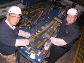 Hiro Nomura (left), president of Toyotetsu Canada, and Edward Bilopaulovic, assistant general manager of production at the company’s Simcoe plant, examine a piece of machinery. Toyotesu’s Park Road facility will undergo a major expansion with the addition of at least 100 jobs over the next two years. (DANIEL R. PEARCE Simcoe Reformer)