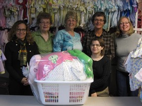 Basically Babies staff display one of their hand-assembled packages that is ready to send out to a family in need. RAYANNE FORBES/SPECIAL TO THE EXAMINER