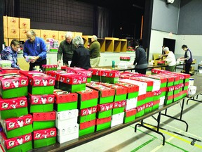 Gert Baron, left, Harry Holtz, Winston Baron, Shawna Holtz, John Rumsey, Tammy Novack, Edna Giroux, Bill Jeffrey and Sharon Jeffrey work their way through hundreds of Operation Christmas Child boxes in the gym at the Pembroke Pentecostal Tabernacle. Once the boxes are packed in Pembroke they make their way to Kitchener on their way to a needy boy or girl in far-flung locales like Haiti, Uruguay or Senegal.