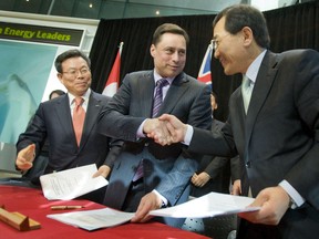 Ontario Minister of Energy and Infrastructure Brad Duguid shakes hands with Samsung C&T corporation brass after signing a green energy agreement at the Toronto Stock Exchange Gallery on January 21, 2010.