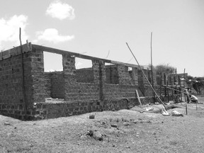 School classrooms rising from the dust at the CanAssist -supported Hope School in Mbita, Kenya. The cost of constructing two classrooms with a small administration office is about $16,000. 'What can you build in Canada for $16, 000?' John Geddes asks.