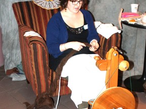 Lakeland Employee Erika Higgins does a wool-spinning demonstration at Lakeland College’s pioneer theme centennial kick-off dinner Saturday evening.