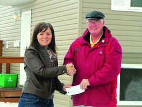 Sharon Moran, advertising coordinator for Homes for the Holidays, presents chair Larry Muirhead from Habitat for Humanity with a cheque for $13,000 raised from the event. This brings the total amount Homes for the Holidays has raised for Habitat to over $100,000. (ROBIN DUDGEON/THE DAILY GRAPHIC/QMI AGENCY)