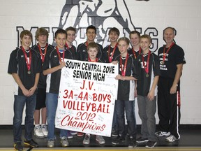The George McDougall JV boys’ volleyball team proudly display the 3A/4A zone banner they won in Okotoks on Saturday.