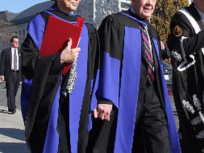 Rosalynn and Jimmy Carter walk out of Grant Hall following convocation ceremonies Wednesday morning.