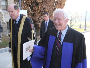 Former president Jimmy Carter walks with Queen's University chancellor David Dodge into Grant Hall for Wednesday's convocation ceremony, in which the Carters both received honorary degrees. (Michael Lea/The Whig-Standard)