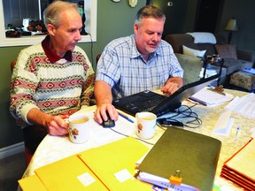 Brothers Graham and Brant Burrow review a petition they have prepared for presentation Monday, calling for a more responsive Elizabethtown-Kitley Township municipal council.
(NICK GARDINER/The Recorder and Times)
