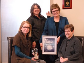 PACE employees–therapist Amanda Unsworth (left), in-house support co-ordinator Rhonda Rousell, executive director Jacquie Aitken-Kish and therapist Susan Marshall– proudly display the Alberta Inspiration Award the organization won for its work in family violence in the Peace Country. (Patrick Callan/Daily Herald-Tribune)