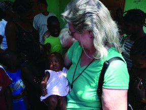 Pastor Joyce Wiebe of Christ Church in Portage la Prairie pictured with orphans in Haiti. Wiebe will be traveling with her husband Abe and friends Jim and Kate Sanderson to Haiti in February 2013 to work in the God's Love for Orphans and Widows (GLOW) Orphanage and School run by Bettie Snyder. (SUBMITTED PHOTO)