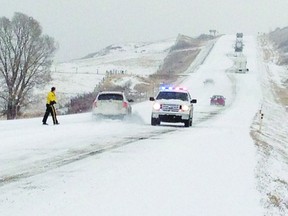 RCMP restricted traffic to one lane on the hill outside Brocket during a winter storm on Nov. 21. Drivers said several semi truck and trailer units had difficulty making it up the hill so RCMP restricted traffic to aid the truckers.