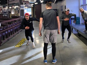 Alex Carnevale, left, and Jordan Addesi, right, race past Alex Galchenyuk, middle as the Sarnia Sting do some dryland training under the watchful eye of strength and conditioning coach Mark Anderson Wednesday at the RBC Centre. PAUL OWEN/THE OBSERVER?QMI AGENCY