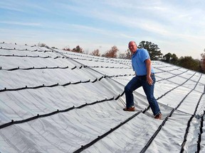 Submitted Photo

Richard Vollebregt, president of Cravo Equipment Inc., stands on a retractable greenhouse roof manufactured by the company at its White Swan Road headquarters in Brant County and distributed around the world.