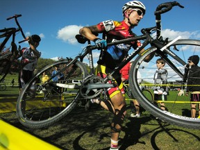 Cyclists jump a barrier at a 2010 cyclocross race in Toronto. A longtime cyclocross race set for Kingston that was expected to attract close to 200 riders was cancelled after organizers and the city could not agree on a new venue. (QMI Agency file photo)