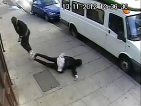 A screenshot from the CCTV showing a girl being punched in an unprovoked attack.