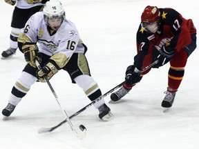 Trenton Golden Hawks' Michael Walker battles for the puck with Wellington Dukes' Abbott Girduckis during the Hawks' 3-2 shootout win Friday at the Essroc Arena. Hawks also clipped the Newmarket Hurricanes 2-1 Sunday at the Community Gardens.