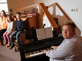 Three Quinte students and singers, from left, Ella Wanless (Grade 8 classical voice), Payton Denyes (Grade 1 classical voice) and Dixon Grimes (Grade 1 contemporary voice) have received the highest marks from their music/voice exams in all Ontario. They are seen here with their music/voice teacher Michael Faulkner at Holy Trinity Lutheran Church in Belleville Thursday.