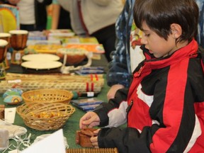 Aaron Lavoie, 8, was enjoying solving the artisan crafted puzzles Friday night at the Ten Thousand Villages Festival Sale.