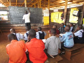 A teacher gives a lesson at Golden Age Community School in Mpigi, Uganda, where there are very few books. The students and staff of North Ward School in Paris, Ontario have collected more than 100 books to send to the African school in October and November 2012, but must now raise $600 to ship them. SUBMITTED PHOTO