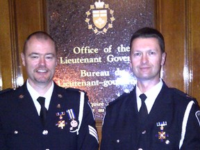 Woodstock police Sgt. Neil Butler, left, and Const. Richard Sziklai were awarded the Ontario Medal for Police Bravery by Ontario’s Lieutenant Governor the Honourable David C. Onley Thursday, Nov. 22, 2012 at Queen's Park.