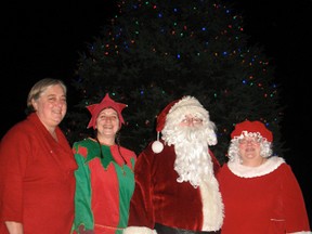 Delhi's Citizen of the Year, Pat Loncke, visited with Santa's helper, Leanna Serrador -- also known as Sticky-Toes the Elf -- Santa Claus and Mrs. Claus at the Delhi BIA's Christmas tree lighting ceremony on Nov. 16 at the Delhi Tobacco Museum and Heritage Centre. (SARAH DOKTOR Delhi News-Record)