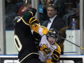 Bryan Moore, right, of the Sarnia Sting is checked by London Knights defenceman Kevin Raine Thursday, Nov. 20, 2012 at the RBC Centre in Sarnia, Ont. PAUL OWEN/THE OBSERVER/QMI AGENCY