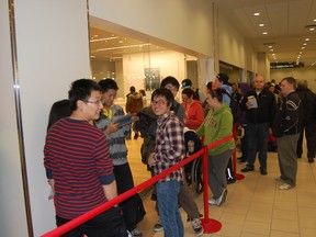 More than 100 people formed a long line when the Jump+ Apple reseller opened in Sudbury Friday morning. (Jonathan Migneault, The Sudbury Star)