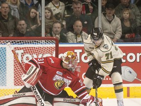 London Knights forward Chris Tierney, right, tries to dig the puck away from Owen Sound Attack goaltender Jordan Binnington during their OHL hockey game at Budweiser Gardens in London on Friday November 16, 2012. (CRAIG GLOVER, The London Free Press)