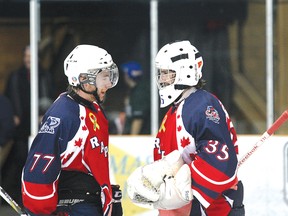 North Bay Trappers goalie Dustin Hummel, right, is congratulated by teammate Tait Seguin after Hummel’s second straight shutout, a 7-0 win over the Sudbury Nickel Barons, Friday.(Ken Pagan, The Nugget)