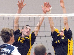 Stratford St. Michael Warriors' John Liotta, at right, and Brendon McLeod make the block against top-seed St. Catharines Eden High School at the OFSAA AA senior boys volleyball championships Friday. SCOTT WISHART The Beacon Herald