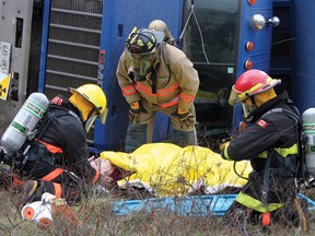 Laurentian Hills and Deep River firefighters prepare to evacuate this “victim” during a mock disaster in Chalk River Friday. The scenario involved an overturned tractor trailer carrying radioactive material. For more community photos please visit our website photo gallery at www.thedailyobserver.ca.