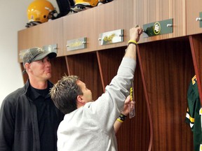 Edmonton Eskimos Jason Maas gets his name plate from Equipment Manager Dwayne Mandrusiak in the Commonwealth Stadium locker room in Edmonton on Thursday, May 26, 2011.  Maas sign a contract with the Eskimos and then retired.        PERRY MAH/EDMONTON SUN  QMI AGENCY