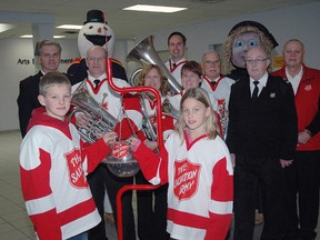Salvation Army Capt. Mark Hall, back left, with mascots Frosty the Snowman and Sally Ann and a group of Salvation Army volunteers who launched this year's kettle drive at the Timken Centre during the St. Thomas Stars' game last Sunday. Volunteers are needed to man the kettles and you can get more information at 519-631-6202.
