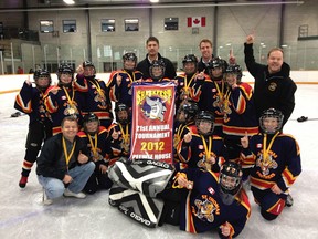 St. Thomas Panthers display their winning banner from the Barrie Sharks Peewee LL Tourney. Back: head coach Darrell Crossett, left, assistant coach Andy Sheridan.
Middle: Audrey Sheridan, Julia Conrad, Shelby Vanderkooy, Mouser Crossett, Taylor Goodhue, Nicole Williamson, Raylee Hind, Heather Dennis and assistant coach Paul Conrad. Front: team mascot Chris Waite, Goose Waite, Zoe Goodhue, Caryn Murphy, Amy Conrad, Madison Murray. On ice: Emily Sanderson.
