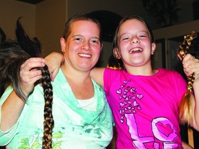 Heather Helberg and daughter Shiloh cut of more than twelve inches of hair Sunday for donation to Angel Hair For Kids, organization that makes wigs for children. SUPPLIED PHOTO