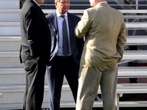 Members of the 2012 Edmonton Eskimos management team, from left, CEO Len Rhodes, chairman Allan Sawin, and then-GM Eric Tillman chat prior to the official team photo at Commonwealth Stadium on Sept. 20.
Perry Mah/Edmonton Sun