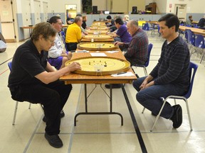 Crokinole competitors Fred Slater of Toronto, left, gets set to shoot against opponent Peter Tarle of Belleville in this 2012 file photo. (JAMES MASTERS/QMI/The Sun Times)