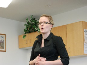 Caylee Tietjen leads the Parkinson's singing group through some warm up exercises during a meeting. This week, the group will be taking their talents around to the retirement homes as they perform Christmas carols. (DHT file photo)