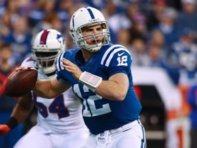 Indianapolis Colts quarterback Andrew Luck looks to get a pass of as Buffalo Bills defensive end Kyle Moore pressures on Sunday in Indianapolis. (REUTERS)