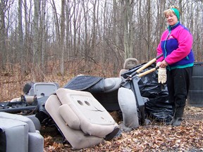 Kathryn Burnham staff photo
Lise Proulx, a member of the Friends of the Summerstown Trails, stands with the car seats pulled from the forest where they were dumped by litterers in the past.