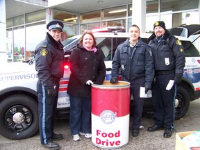 KATHRYN BURNHAM staff photos
OPP auxiliary office LAnce Dixon, Agape Centre's Lori Berkley, Cornwall auxiliary office Daniel Spooner and OPP auxiliary ofice Doug Behr manned the food drive at Baxtrom's Independent Grocer Saturday, where generous shoppers donated 10 bins of food by mid-morning.