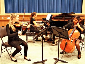 KARA WILSON, for The Expositor

Emma Morrison (left), Rebecca Orsini and Magali Toy perform Sunday at the Brantford Contemporary Showcase at W. Ross Macdonald School. The inaugural music festival, which continues Monday, attracted more than 100 participants.