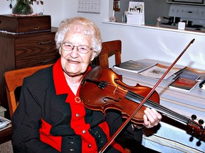 KARA WILSON, for The Expositor

Muriel Stephenson, who will celebrate her 90th birthday in January, plays Silent Night on her violin. On the table next to her are some of the books of poems that she has published.