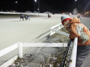 O'Sean Young, 6, watches the horses and drivers warm-up on the track prior to the first race at Sudbury Downs on Saturday, November 24, 2012. JOHN LAPPA/THE SUDBURY STAR/QMI AGENCY